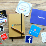 notepad and social media stickers for creating a social media plan